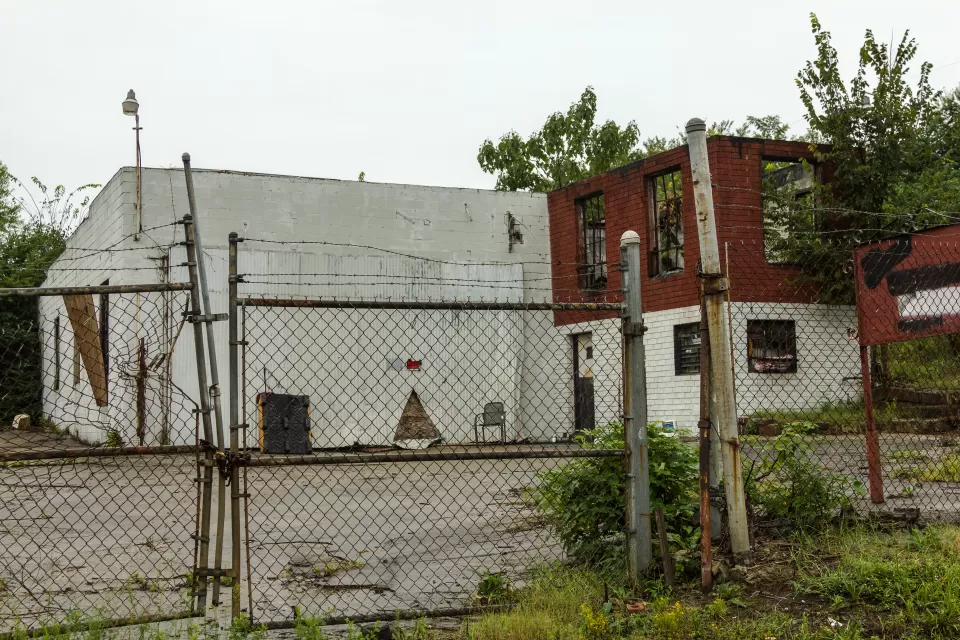 Abandoned, decaying building behind locked chain link fence in Atlanta, Georgia
